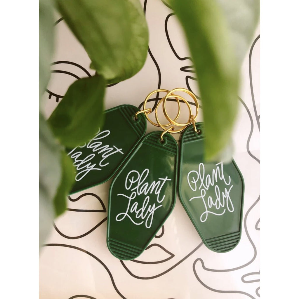 green plant lady retro motel keychain with white letters
