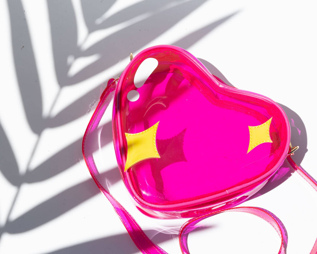 Heart-shaped pink bag with yellow stars on a white background
