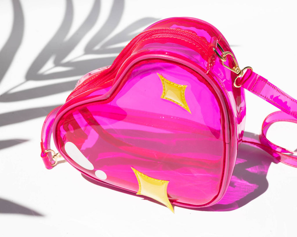 Pink heart-shaped bag with yellow stars on a white background