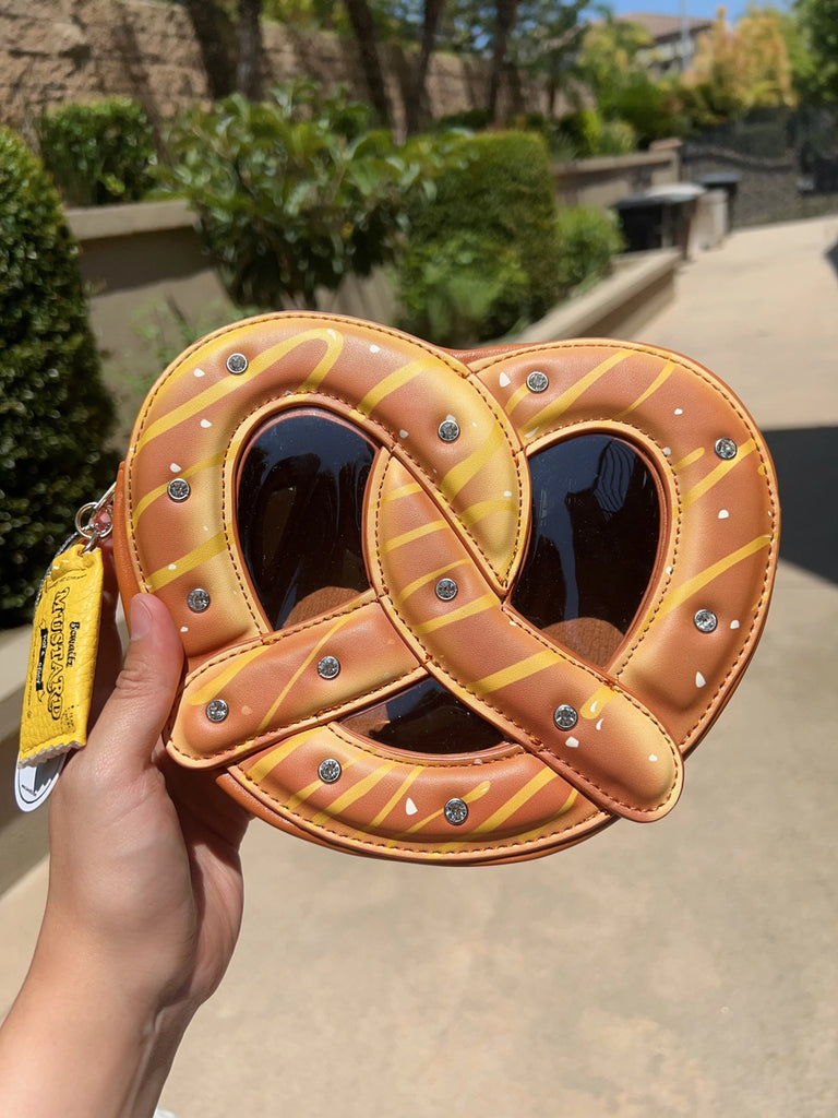 hand holding  a pretzel purse bag 