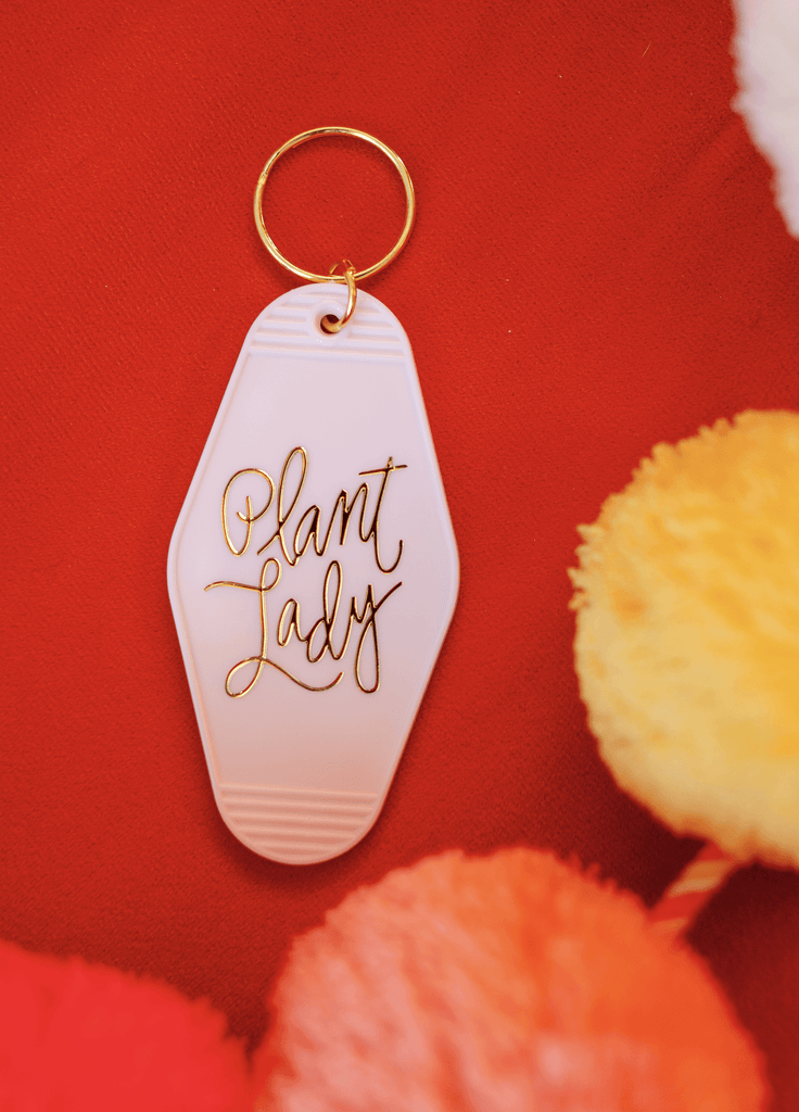 white plant lady retro motel keychain with gold letters